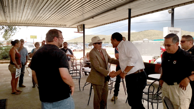 District Attorney Rod Ponton (center, in hat) shakes hands with the congressman. (Rebecca Hagerman, photo)